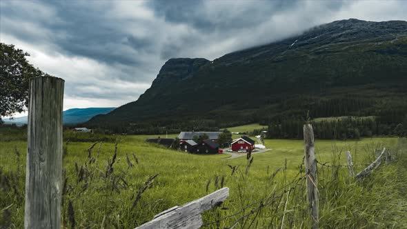 Red Barn And Farmhouse Built By The Mountains Of Hemsedal Norway - timelapse shot alt