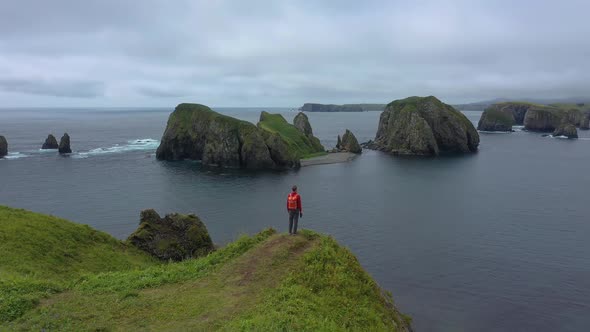 Traveler Standing on a Cliff and Looking on Beautiful Unnamed Bay, Shikotan Island, Russia