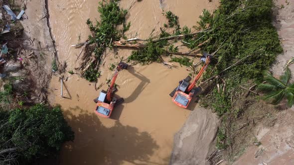 Aerial view two excavator clear the trees after flash flood alt