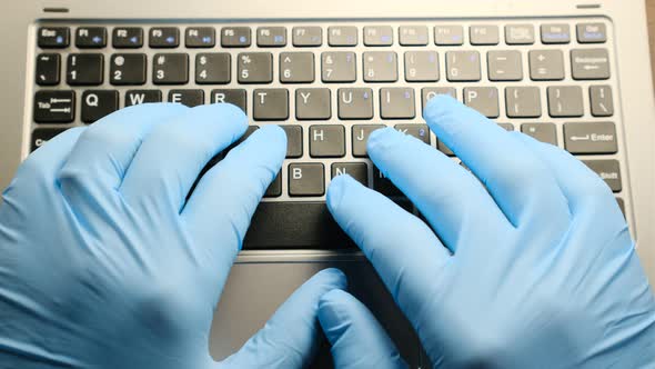 Closeup Doctor in Medical Gloves Typing on Keyboard Prescribing Drugs Hospital