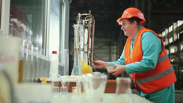 Mature Woman Working in Chemical Plant Focused Female Worker Wearing Hard Hat alt