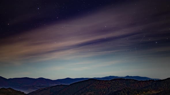 Night Starry Sky with Light Pink Clouds Floating at Twilight