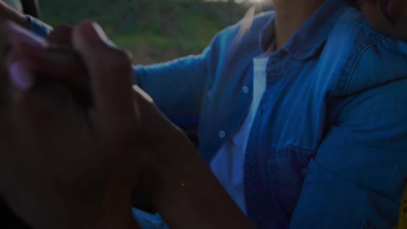 Young couple on a road trip in their pick-up truck alt