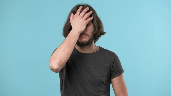 Portrait of Annoyed Bearded Man Covering Face Like Facepalm Expressing Frustration or Shame Over alt