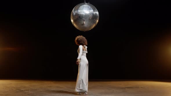 Charming African American Woman in Roller Skates Rides Around Under Disco Ball alt