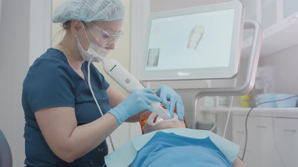 Doctor Scans the Patient's Teeth in the Clinic alt