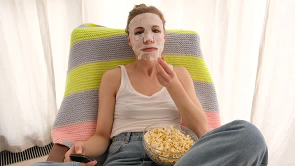 Woman with a Remote and Popcorn alt