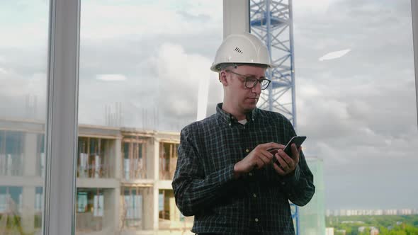 Engineer Using Mobile Phone in Helmet alt