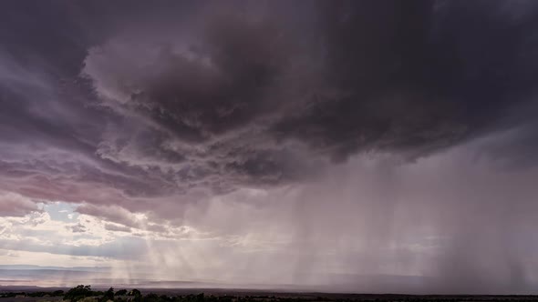 Dark clouds rotating in the sky in front of monsoon storm in Utah alt