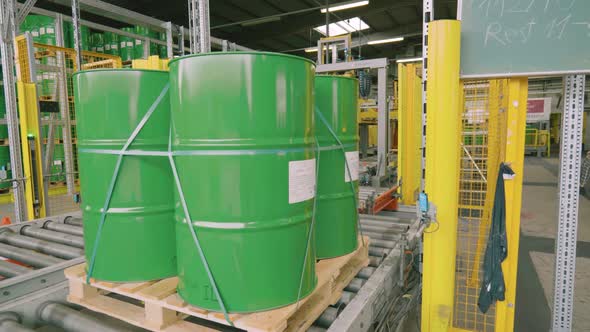 Metal Barrel with Oil on a Conveyor Belt alt
