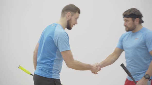 Young Fit Sportsman Welcoming Client in Gym. Portrait of Confident Handsome Caucasian Man alt
