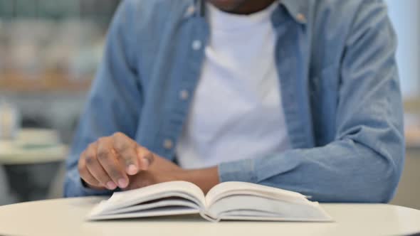 African Man Reading Book Close Up alt