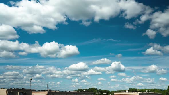 The Movement of Many Small Clouds Over the Rooftops alt
