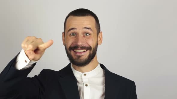 A Young Handsome Businessman in a Blue Suit Is Looking at the Camera and Laughing. alt