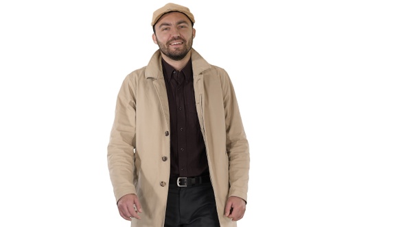 Smiling man in coat is looking at camera and walking on alt