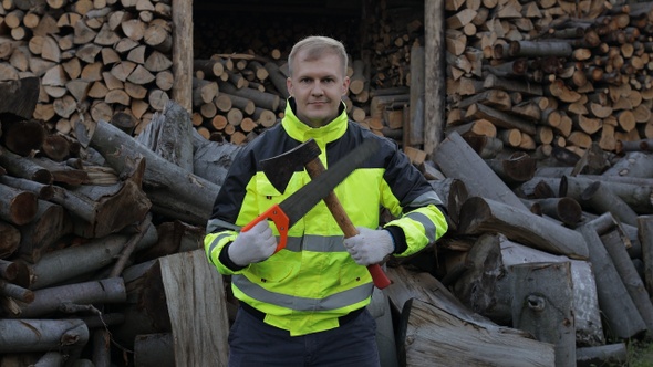 Lumberjack in Reflective Jacket, Man Woodcutter Holds Small Axe and Saw on His Hands, Firewood alt