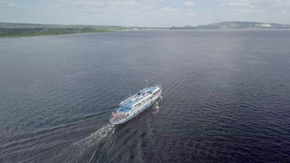Aerial View of Moving Motor Ship on Wide River in Summer Sunny Day