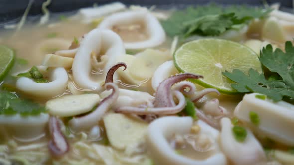 Close-Up Footage of Hot and Sour Squid in Chilli, Garlic and Lime Soup alt