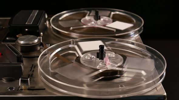 Vintage Reel to Reel tape recorder playing music close up of reel alt