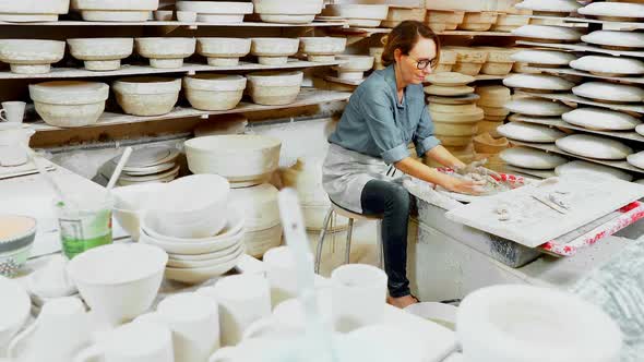 Female potter molding a clay alt