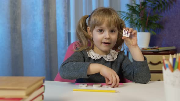 Child Girl Doing School Homework Teach Alphabet Letters with Teacher at Home Video Call By Webcam alt