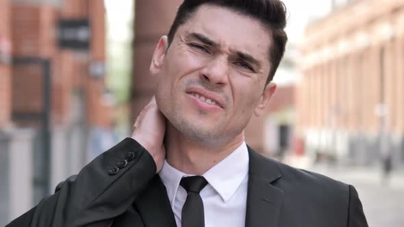 Outdoor Tired Businessman with Neck Pain alt
