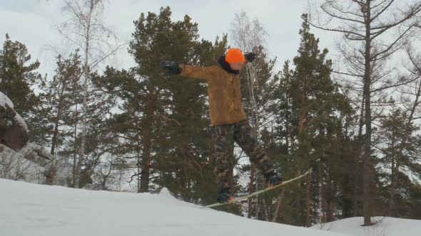 A Young Man Snowboarding