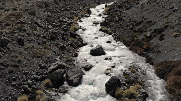 Aerial Drone shot following river with strong current at Cajon del Maipo, Chile-4K alt