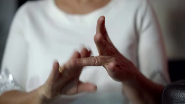 Woman Is Clapping on Fingers of Her Hand, Massaging Joints, Ayurvedic Procedure alt