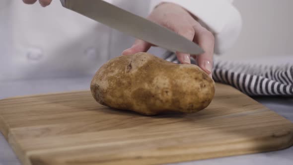 Step by step. Slicing russet potatoes in wedges with olive oil and spices to bake in the oven. alt