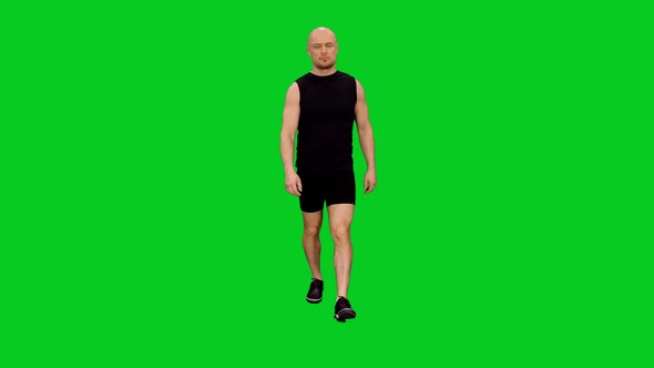 Adult Male Athlete Walking Towards The Camera against Green Screen