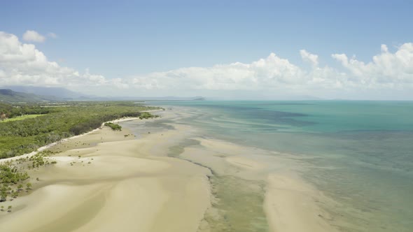 Aerial, Low Tide And Huge Sand Ocean Bed And Mangroves Growing In Queensland Australia