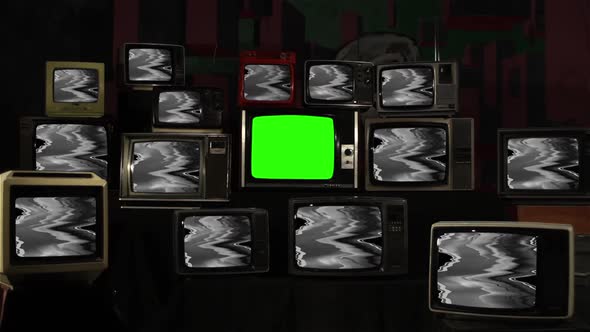 Stack of Vintage TV with Glitch Effect and Green Screen. alt