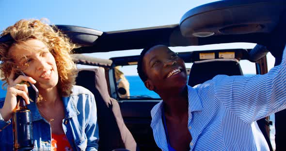 Female friends having fun in the car  alt