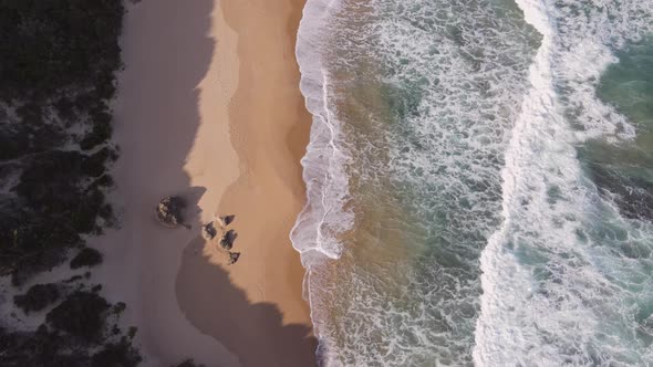 Drone Flying Over Coastline with Water Seen Rushing in