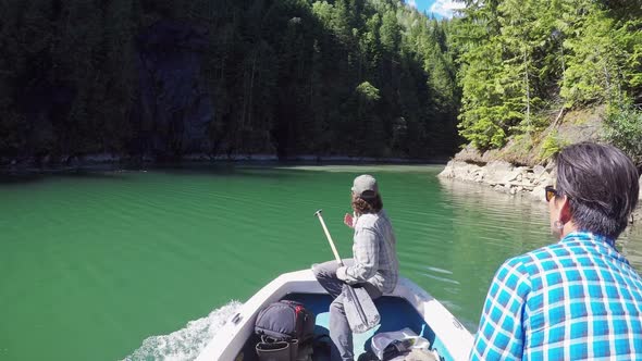 Two men riding a fishing boat in the river 4k alt