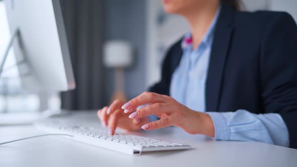 Woman in Glasses Typing on a Computer Keyboard. Concept of Remote Work. alt