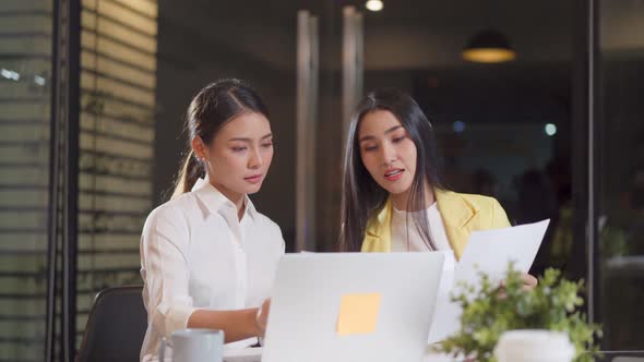 Asian young business woman people group have discussion meeting, work in office as teamwork overtime alt
