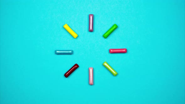 Colored Candy Sticks Appear in a Circle and Blink. Colorful Loading Sign From Candies. Stop Motion alt