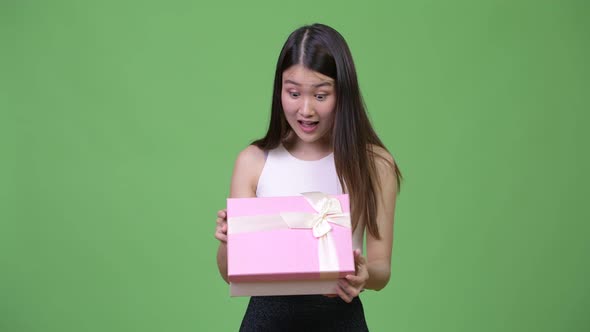 Young Beautiful Asian Businesswoman Opening Gift Box