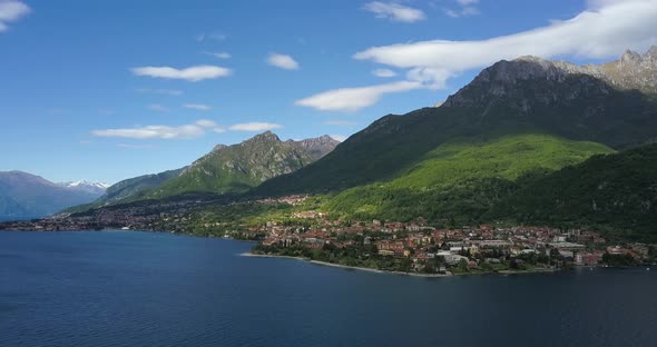 Great View From Drone To Como Lake, Old Town and the Mountains in Italy. Drone Flies Over the Water