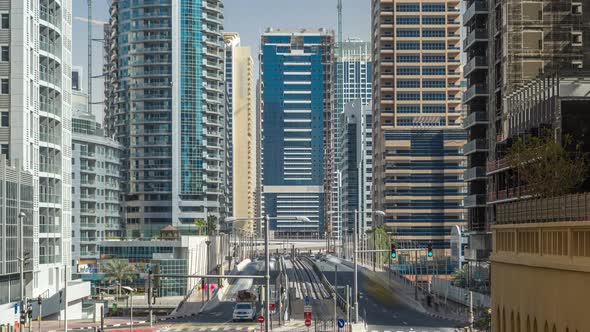 Dubai Marina with Skyscrapers Timelapse and Traffic on the Street Near Concrete Road Bridge Through alt