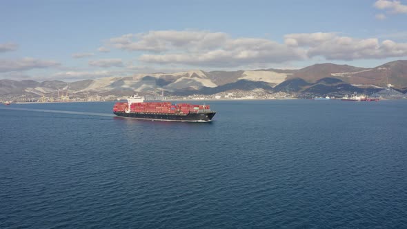 Ultra Large Container Ship Sailing at Sea Aerial Side View Footage