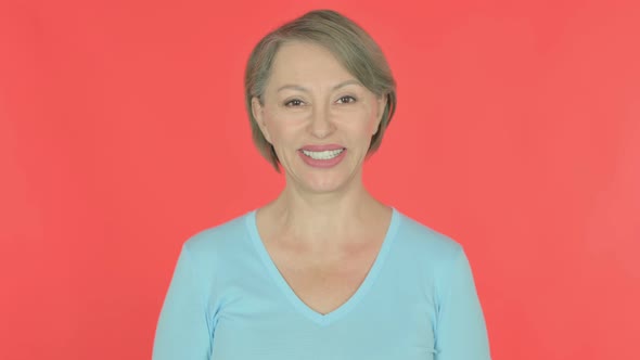 Smiling Old Woman on Red Background alt