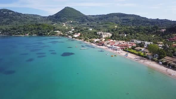 Greece, Corfu Island, drone footage of Messonghi Beach, Moraitika. Flying forward and making a left alt
