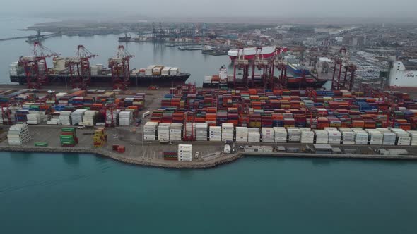 Drone video of shipping container yard on the sea port of Callao, in Peru. Many colored containers a alt