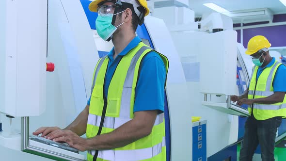 dolly shot of young caucasian technicians work manage inspecting with control screen alt