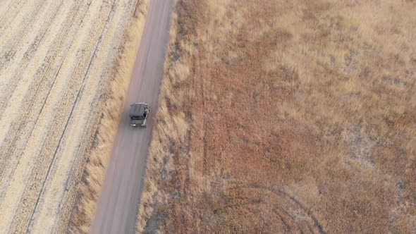 Ranger Driving Down Dirt Road in Utah Mountains in the Fall During Dusk Top Aerial Drone View 4K alt