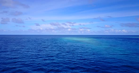 Wide angle birds eye island view of a sunshine white sandy paradise beach and blue water background  alt