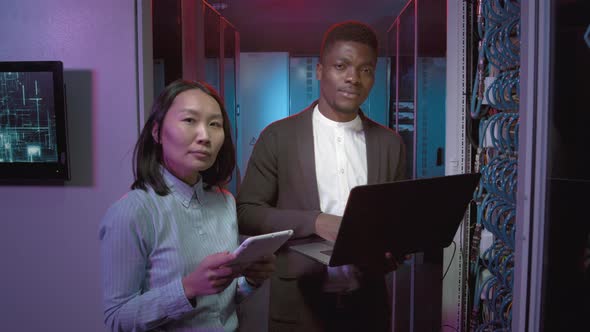 Network Engineers Posing in Data Center alt